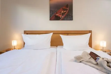 Schlafzimmer FeWo Haubentaucher - Kamin, Sauna, Meerblick