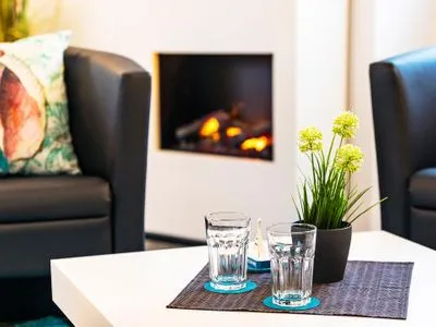 Wohn/Essbereich: Schlafcouch, Sitzbereich, Essbereich, Elektrokamin mit Heizfunktion, TV FeWo Meer geht immer in PRORA - 4.37