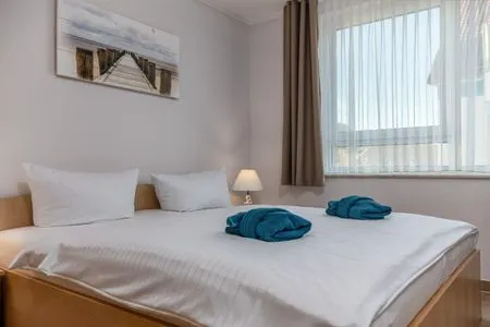Schlafzimmer mit Doppelbett Residenz am Strand Wohnung 4-61
