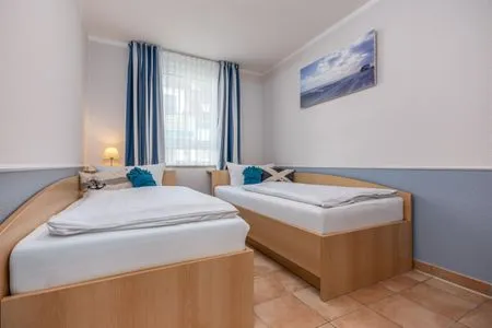 Schlafzimmer mit zwei Einzelbetten Residenz am Strand Wohnung 4-61