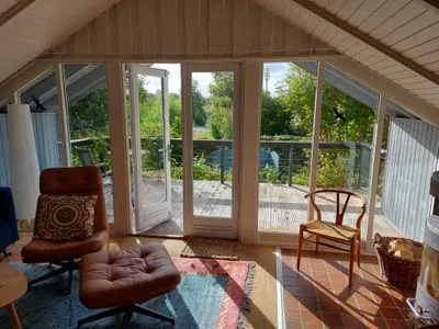 Wohnzimmer mit Blick in den Garten und Kamin Immi's Hus