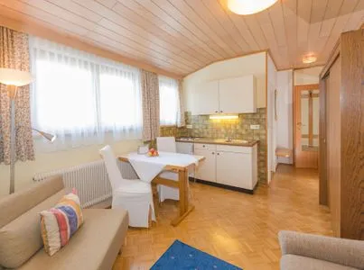 Kitchen with dining area City Life 5 by Alpenidyll Apartments