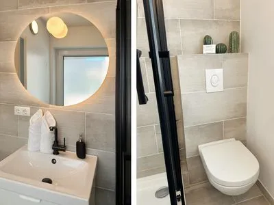 Sauberes und modernes Badezimmer mit Fenster Romantische Ferienwohnung am Hafen mit gratis Bettwäsche-Paket und Terrasse