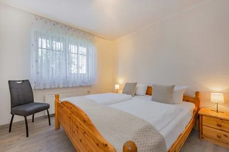 Schlafzimmer Ferienwohnung Wassermann mit Terrasse, Sauna und Blick auf das Achterwasser