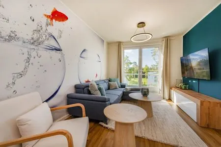Wohnzimmer Ferienwohnung Goldfisch mit Balkon, Wellness- und Kinderspielbereich