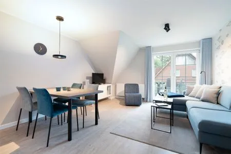 Wohnzimmer, Sofa und Sessel mit Couchtisch und gemütlicher Sitzecke Gorch-Fock-Park Ferienwohnung "App. 31 Hygge"