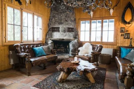 Rustically furnished living room with a fireplace Chalet Theresia