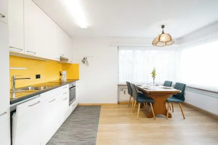 Modern kitchen with dining table Apartment Im Aeschen
