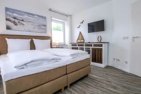 Schlafzimmer mit Doppelbett und TV Parkresidenz am Hafen Wohnung HF 23 - "Viento"