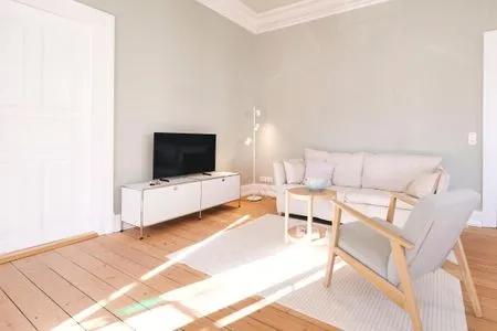 Wohnzimmer mit Couch, Esstisch und TV Villa Rosa