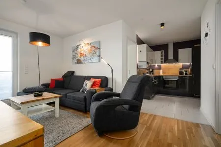 4 Ferienwohnung Fischotter Waren (Müritz) - offener Wohnbereich mit gemütlicher Sitzecke und moderner Küche  Fischotter