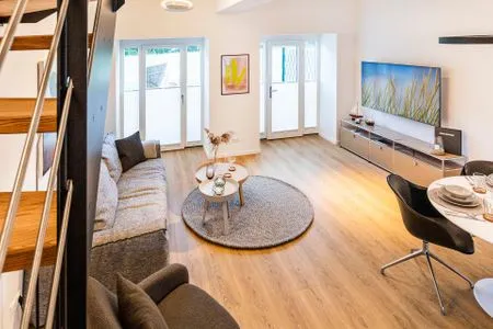 Wohn/Essbereich: Sofa, Sitzbereich, Essbereich, TV-Flachbild, Zugang zur Terrasse FeWo Baltic Beach Home in PRORA - 2.02