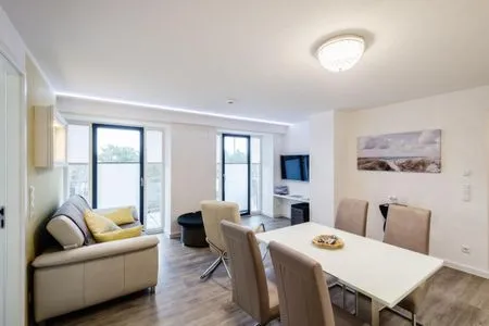 Wohnzimmer: Schlafsofa, TV, Essbereich, Zugang zum Balkon FeWo Sanddüne in PRORA - 6.42