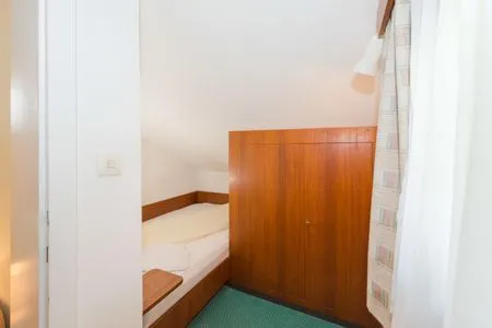Schlafzimmer 2, Einzelbett City Life 4 by Alpenidyll Apartments