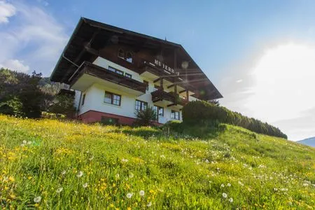 Main view of the building in summer Huberhof 8 by Alpenidyll Apartments