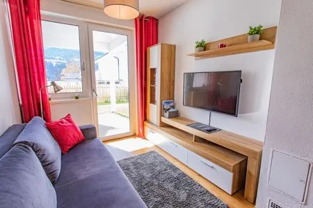 Living room, sofa bed and TV Sunny Aich by Alpenidyll Apartments