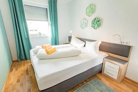 Bedroom with a double bed Sunny Aich by Alpenidyll Apartments