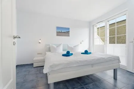 Schlafzimmer mit Doppelbett und Balkon  de Obendtied - Wohnung 4