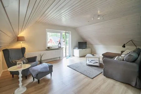 Wohnzimmer Ferienwohnung „Ankerplatz“ am Wittensee – ruhig, nordisch, familienfreundlich mit Spielscheune