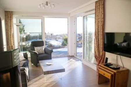 Wohnzimmer mit Kaminofen in der Ferienwohnung Passat im Haus Kap Horn in Wittdün auf Amrum Haus Kap Hoorn Ferienwohnung Passat