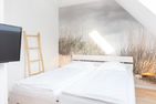  Ferienwohnung 54 Nord Nebel - Schlafzimmerbereich mit einem Doppelbett in der Ferienwohnung 54 Nord in Nebel auf Amrum