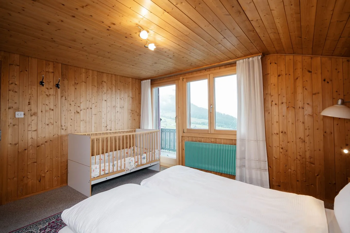 Apartment Sidonie Amden - Schlafzimmer mit Doppelbett und Babybett