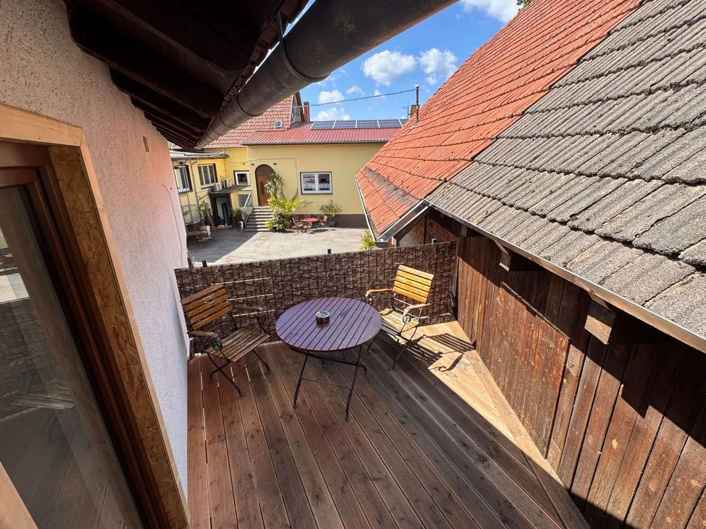 Ferienwohnung Storchennest Thüringer Wald - Neue Terrasse mit Blick auf Gasthaus und die grüne Umgebung