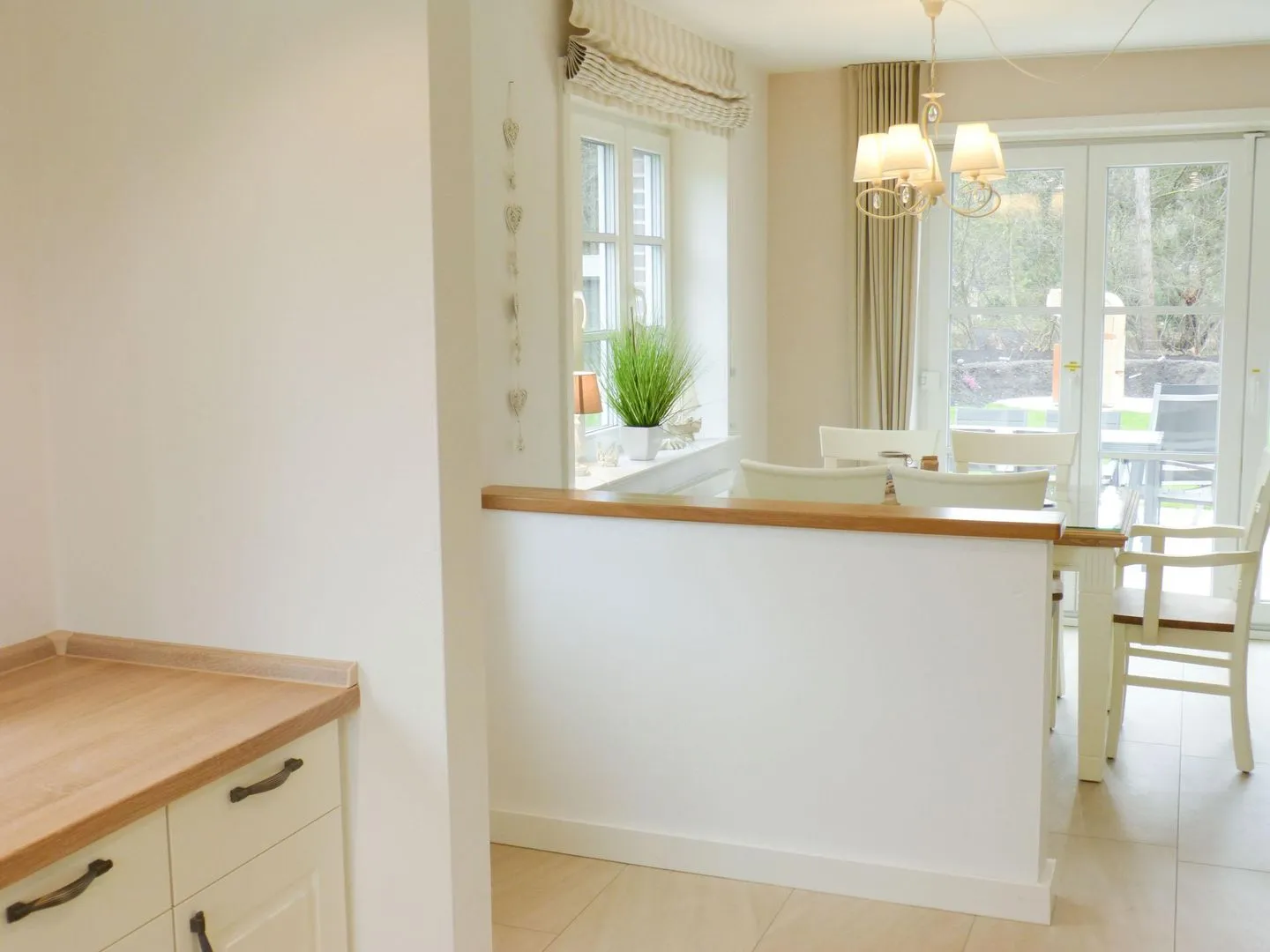 Heidehüs Friesenhaushälfte *Seepferdchen* Süddorf auf Amrum - Esstisch mit Gartenblick in der Ferienwohnung Seepferdchen in Süddorf auf Amrum